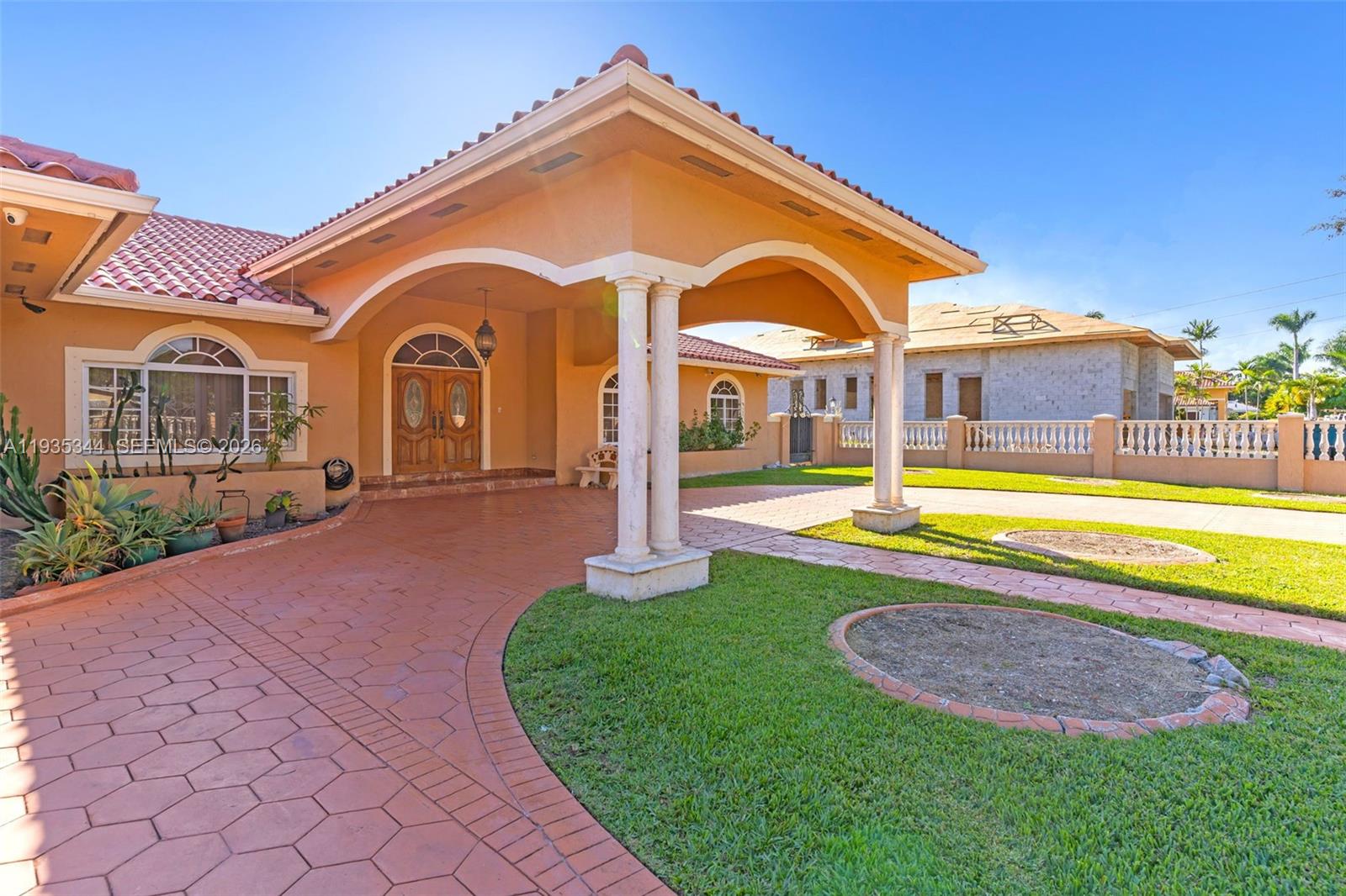 12700 Southwest 188th Street Miami, FL 33177 - Photo 4 of 44 a view of a house with swimming pool and a yard