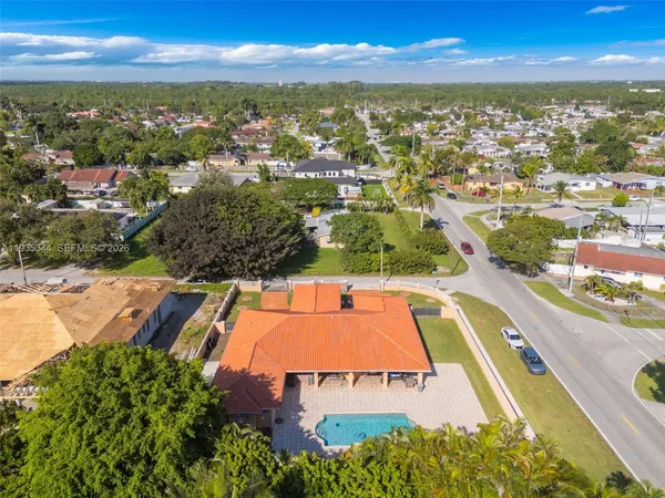 an aerial view of residential houses with outdoor space