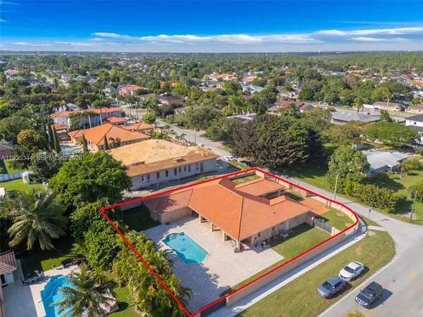an aerial view of residential houses with outdoor space