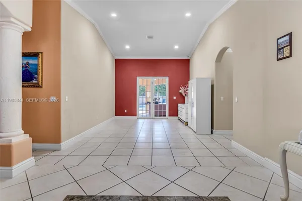 a view of entryway with hallway and a toilet