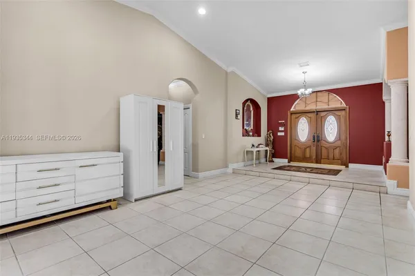 a view of a room with cabinet mirror and window