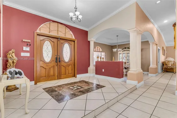 a bedroom with a bed a dresser and potted plants on the dresser