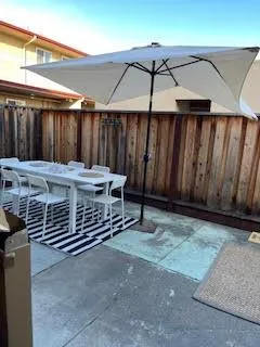 a view of a backyard with wooden fence