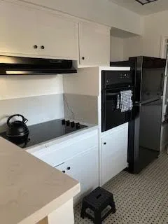 a kitchen with a refrigerator and a stove