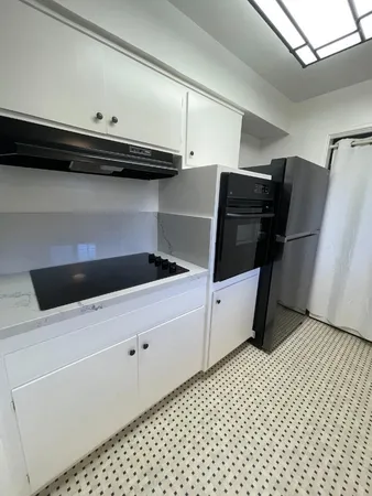 a kitchen with a refrigerator and a stove