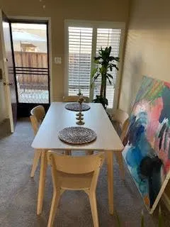a view of a dining room with furniture and window