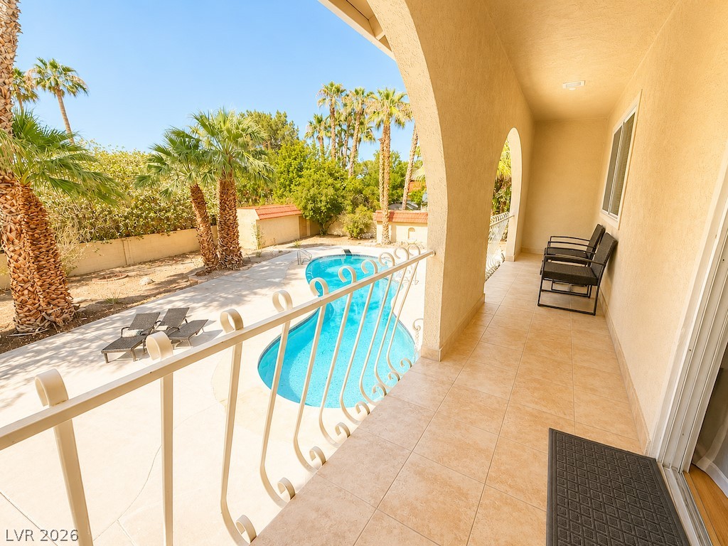 3010 East Viking Road Las Vegas, NV 89121 - Photo 41 of 48 A private balcony offers serene views of the refreshing pool and verdant palms.