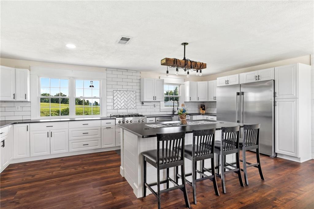 967 Good Intent Road Claysville, PA 15323 - Photo 7 of 50 a kitchen with stainless steel appliances a dining table chairs and wooden floor