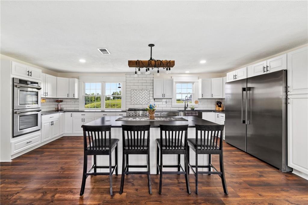967 Good Intent Road Claysville, PA 15323 - Photo 8 of 50 a kitchen with stainless steel appliances a dining table chairs refrigerator and cabinets