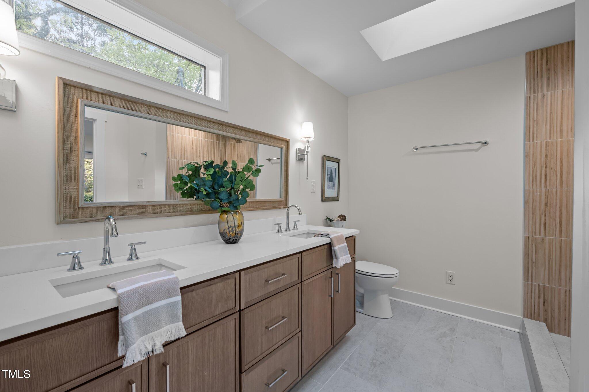 3014 Hope Valley Road Durham, NC 27707 - Photo 17 of 38 a bathroom with a double vanity sink and a mirror
