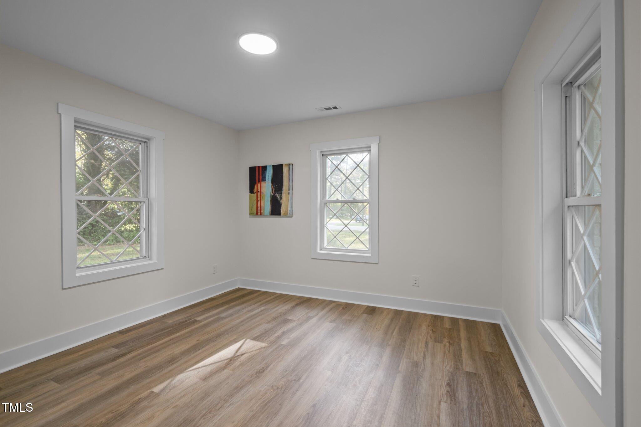 3014 Hope Valley Road Durham, NC 27707 - Photo 20 of 38 a view of an empty room with wooden floor and a window