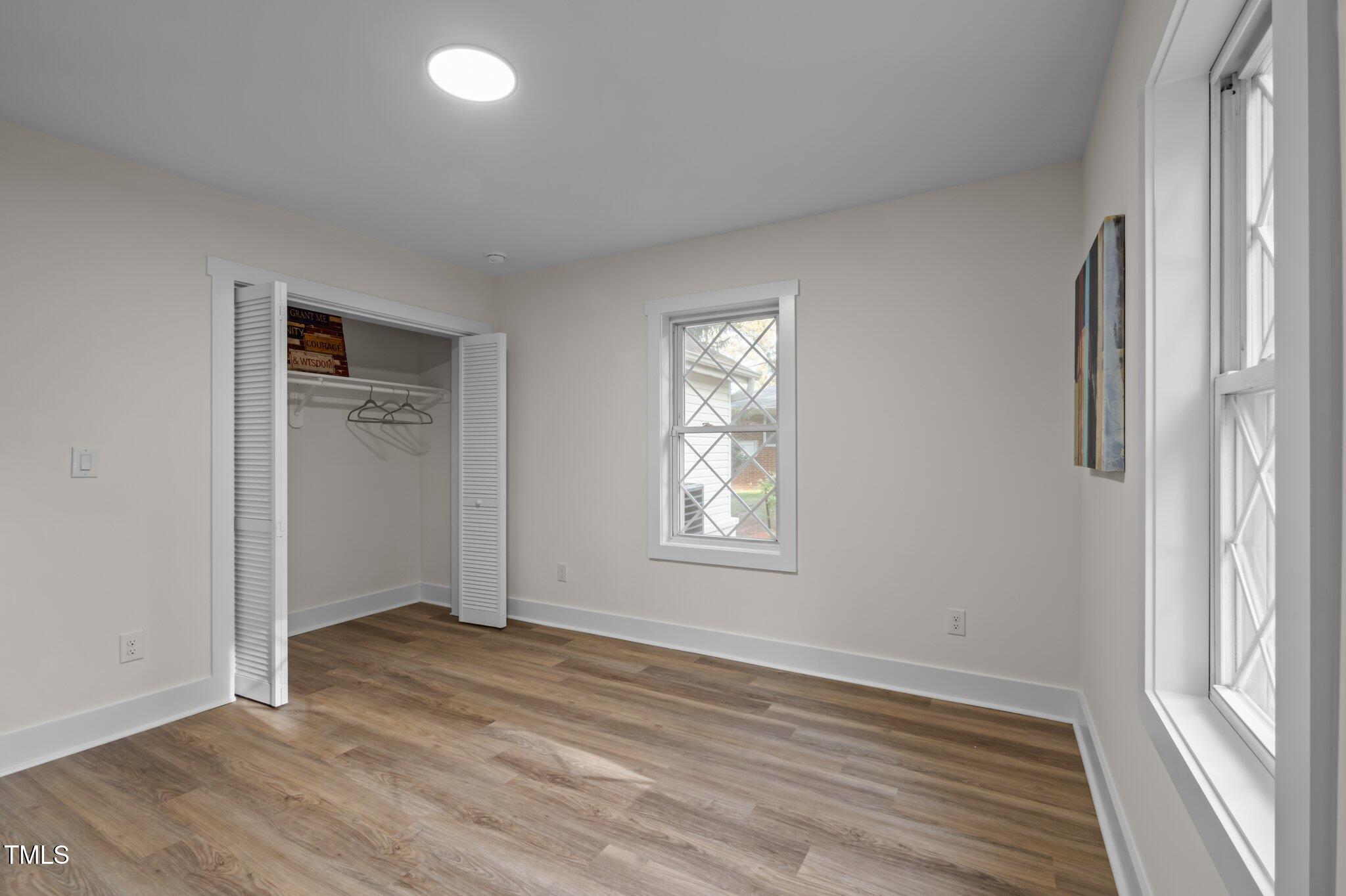 3014 Hope Valley Road Durham, NC 27707 - Photo 21 of 38 an empty room with wooden floor and windows