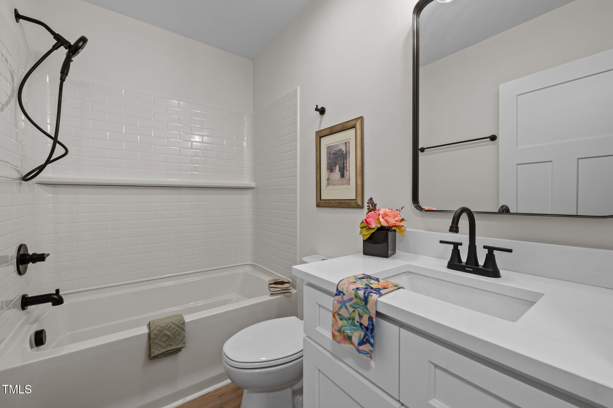 3014 Hope Valley Road Durham, NC 27707 - Photo 22 of 38 a bathroom with a sink a toilet and a mirror
