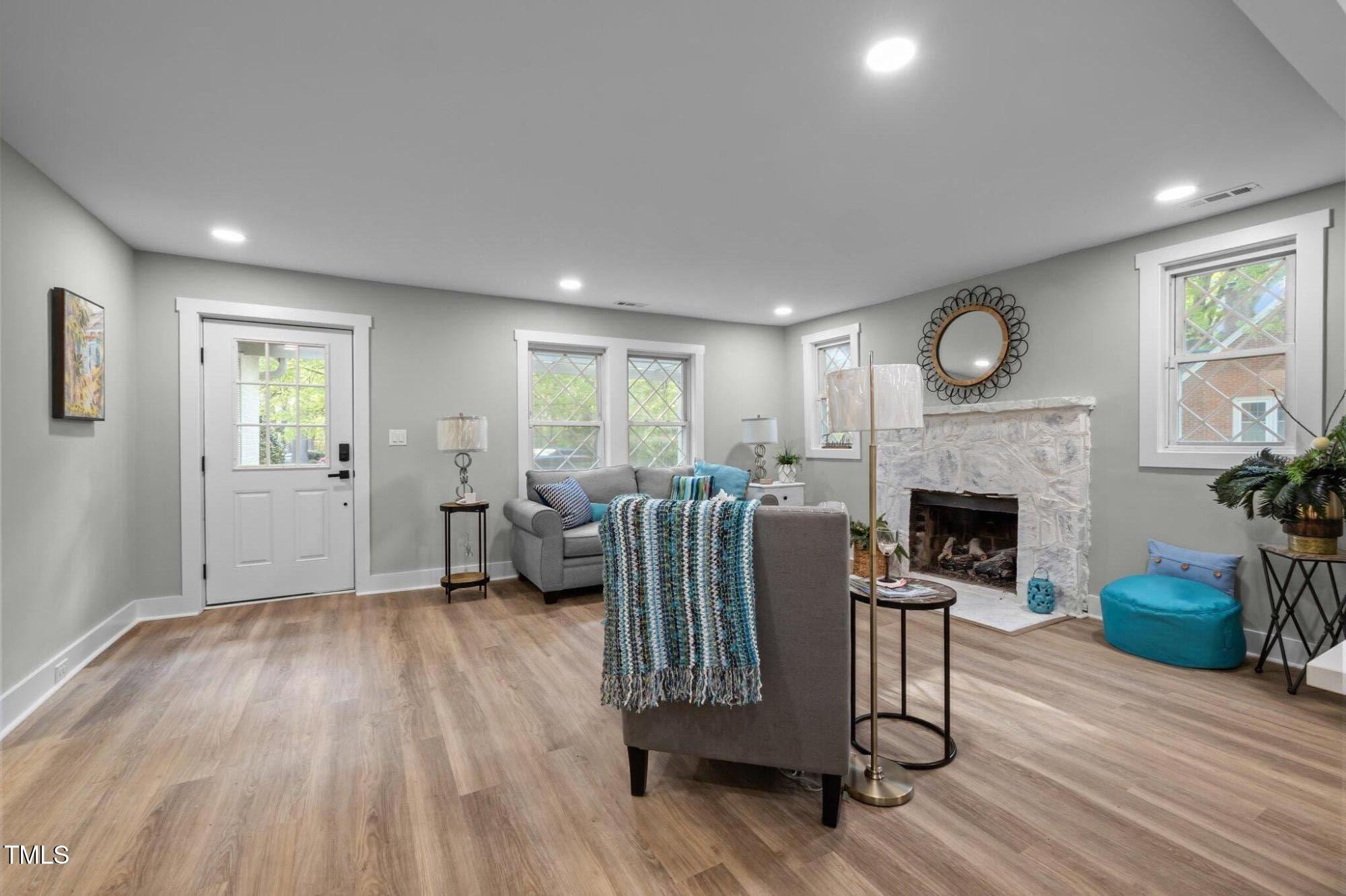 3014 Hope Valley Road Durham, NC 27707 - Photo 6 of 38 a living room with furniture wooden floor and a fireplace