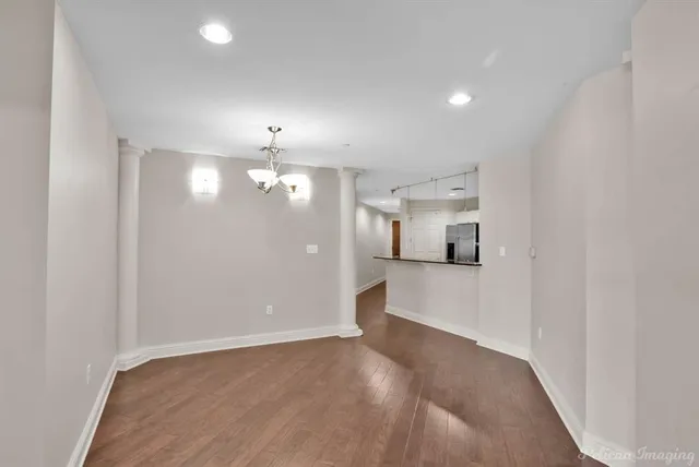 an empty room with windows and cabinet