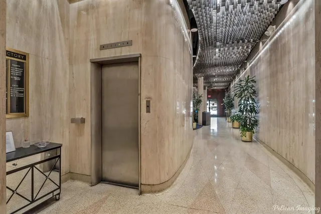 a lobby with furniture and a potted plant