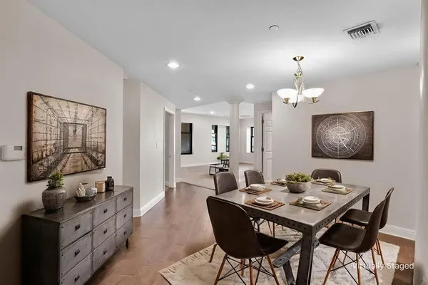 a view of a dining room with furniture and chandelier
