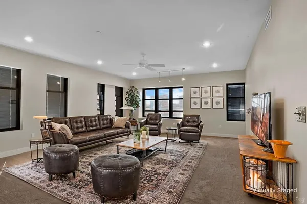 a living room with furniture a rug and a flat screen tv