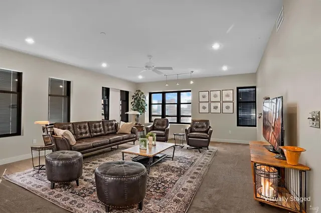 a living room with furniture a rug and a flat screen tv
