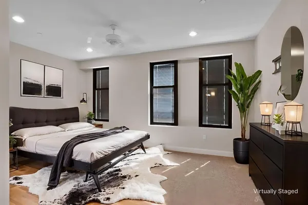 a bedroom with a bed a mirror and dresser