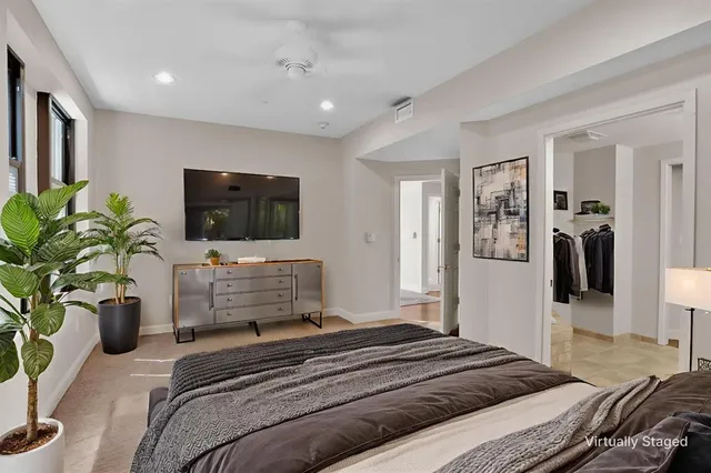 a bedroom with a bed and a flat screen tv