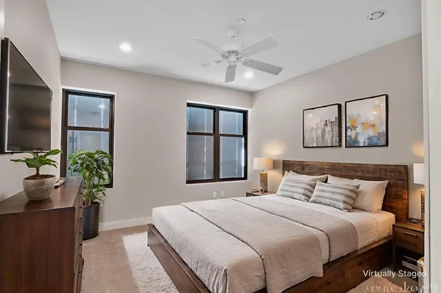 a bedroom with a large bed and a chandelier