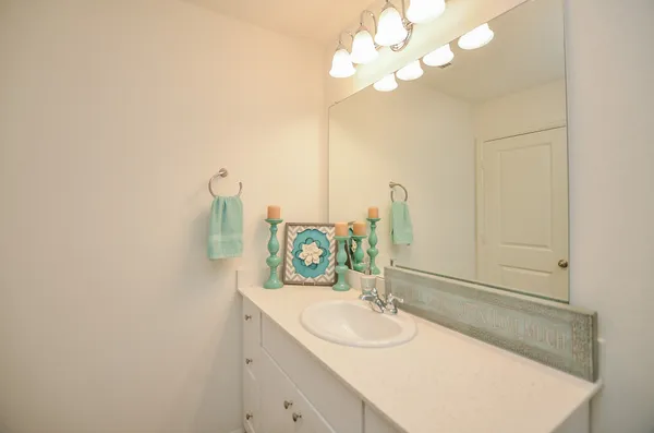 a bathroom with a sink vanity and a mirror
