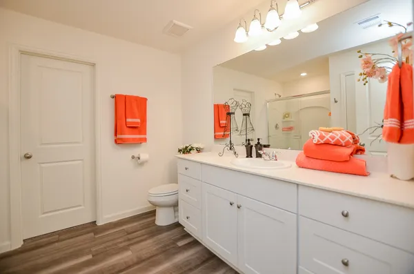 a bathroom with a sink vanity granite and toilet