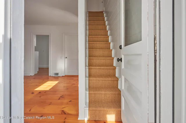 a view of entryway with bathroom and shower