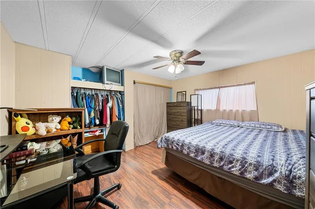 a bedroom with a bed and a book shelf