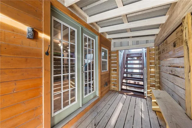 a view of a balcony with wooden floor and iron stairs
