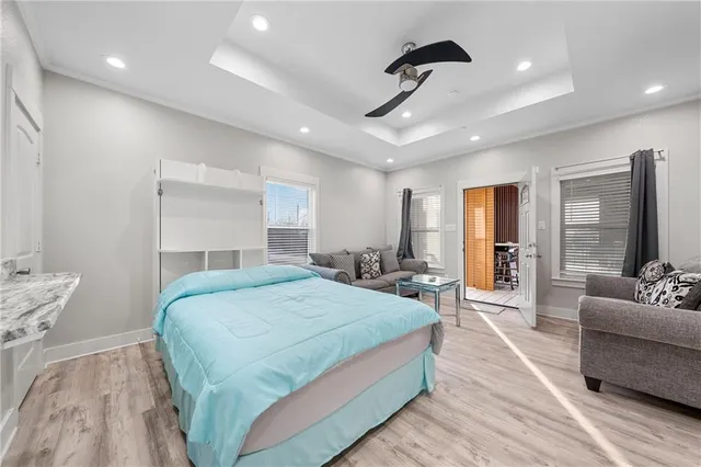 a spacious bedroom with a bed and glass walk in closet