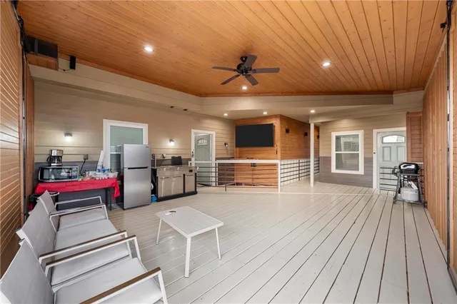 a very nice looking room with wooden floor and furniture