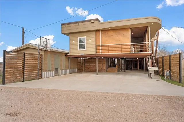 a view of a house with a patio and a yard