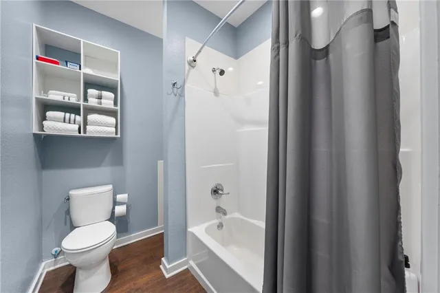 a white toilet sitting next to a bathroom sink and shower