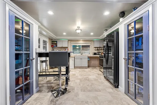 a kitchen with stainless steel appliances kitchen island granite countertop a refrigerator and cabinets