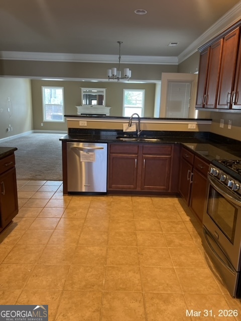10 Winged Foot Way Southeast Covington, GA 30014 - Photo 5 of 12 a kitchen with stainless steel appliances granite countertop a stove a sink and a microwave