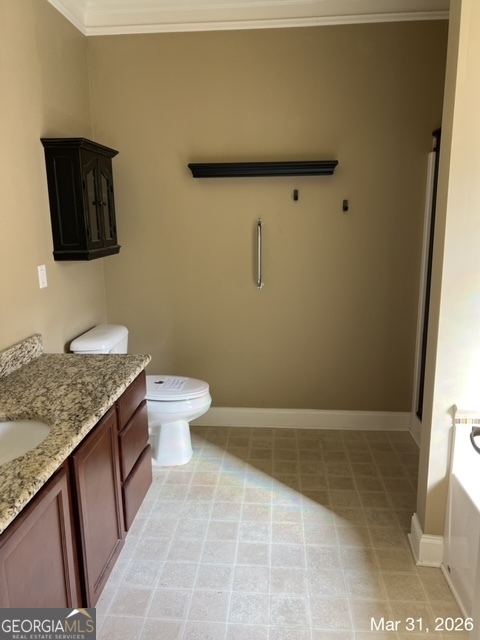 10 Winged Foot Way Southeast Covington, GA 30014 - Photo 7 of 12 a bathroom with a granite countertop sink a toilet and a mirror