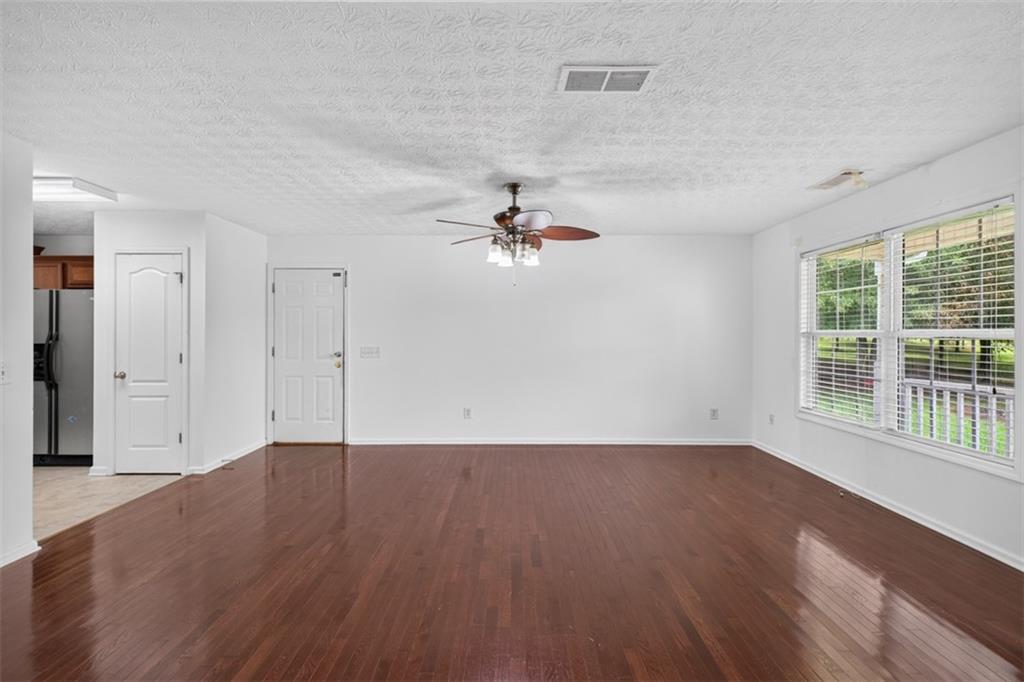 602 Pendergrass Road Winder, GA 30680 - Photo 15 of 44 wooden floor in an empty room with a window