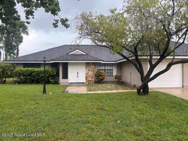a front view of a house with garden and trees