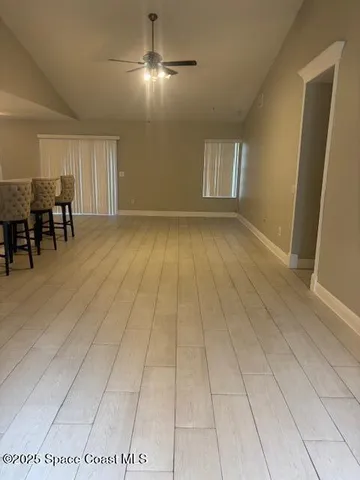 a view of livingroom with furniture and chandelier fan