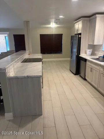 a kitchen with stainless steel appliances wooden cabinets and granite counter tops