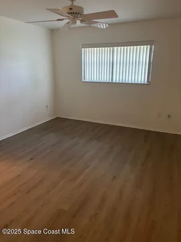 an empty room with wooden floor