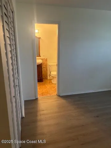 a view of a room with an empty space and a window