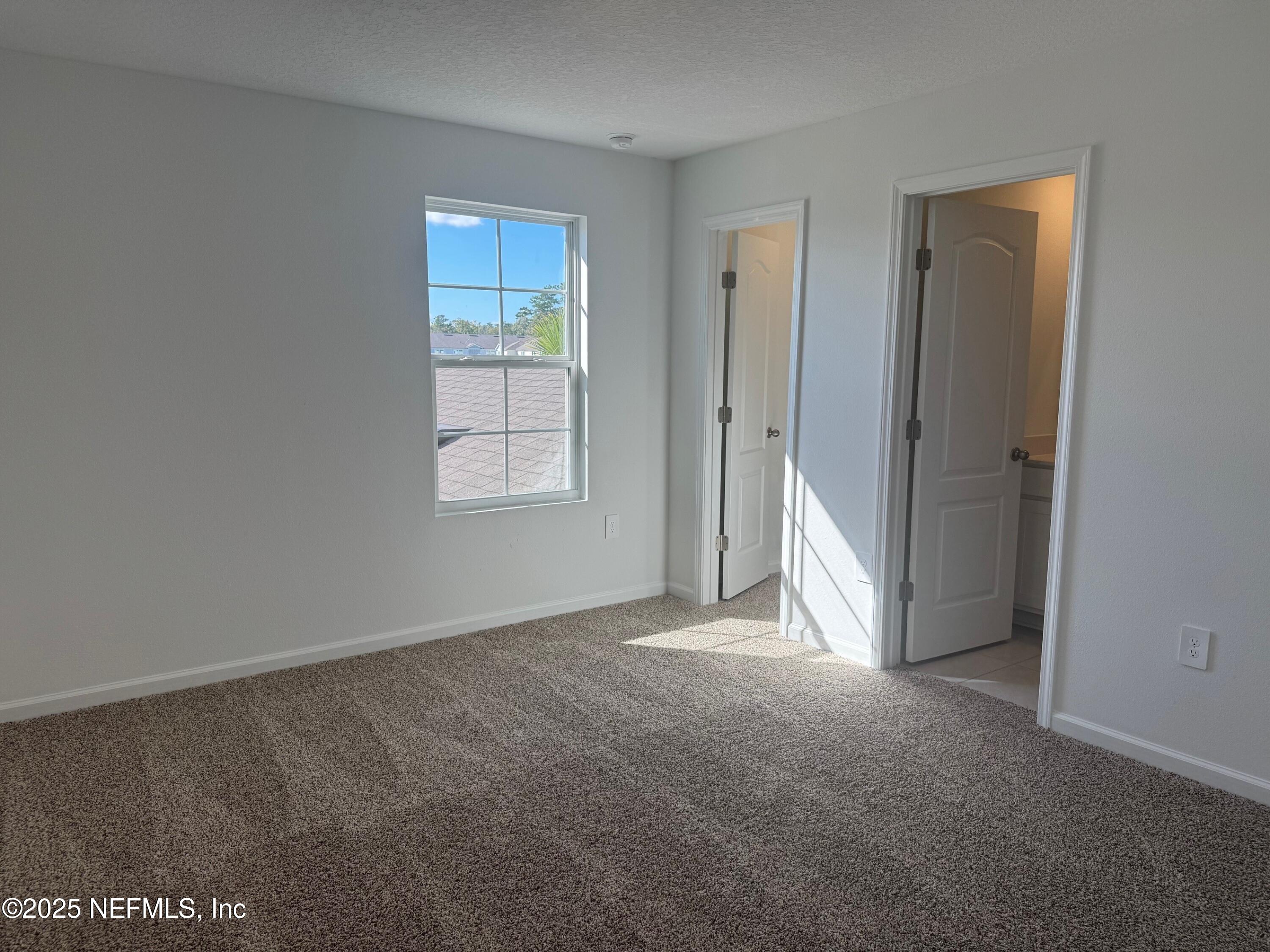 65 Blue Hvn Road St. Augustine, FL 32095 - Photo 21 of 57 an empty room with windows and closet