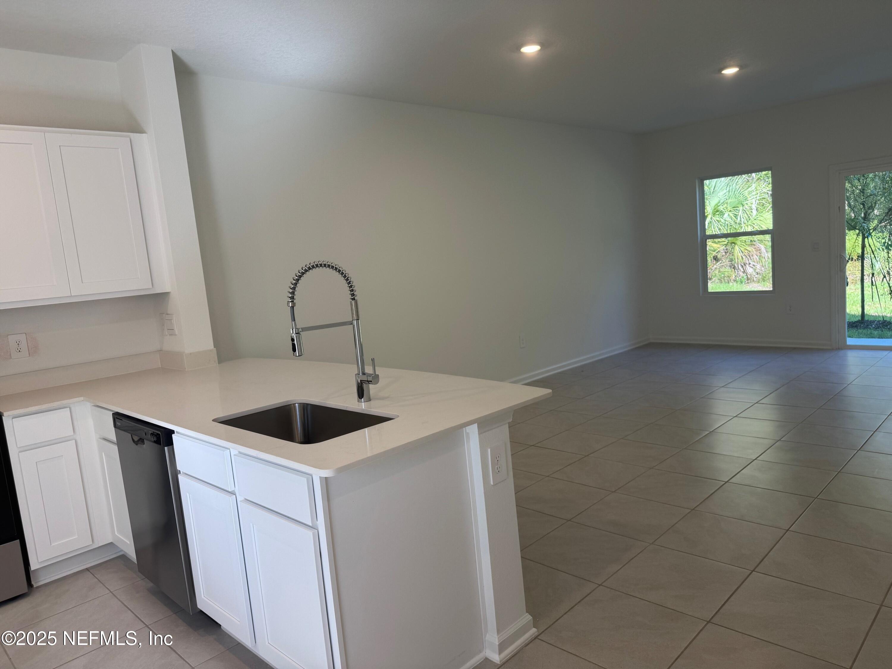 65 Blue Hvn Road St. Augustine, FL 32095 - Photo 9 of 57 a kitchen with a sink and cabinets