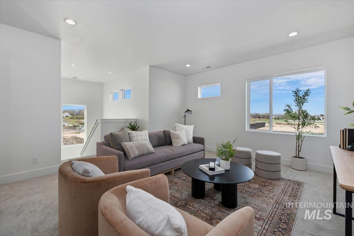 749 South Calhoun Lane Star, ID 83669 - Photo 5 of 34 Living room with light carpet, plenty of natural light, and recessed lighting