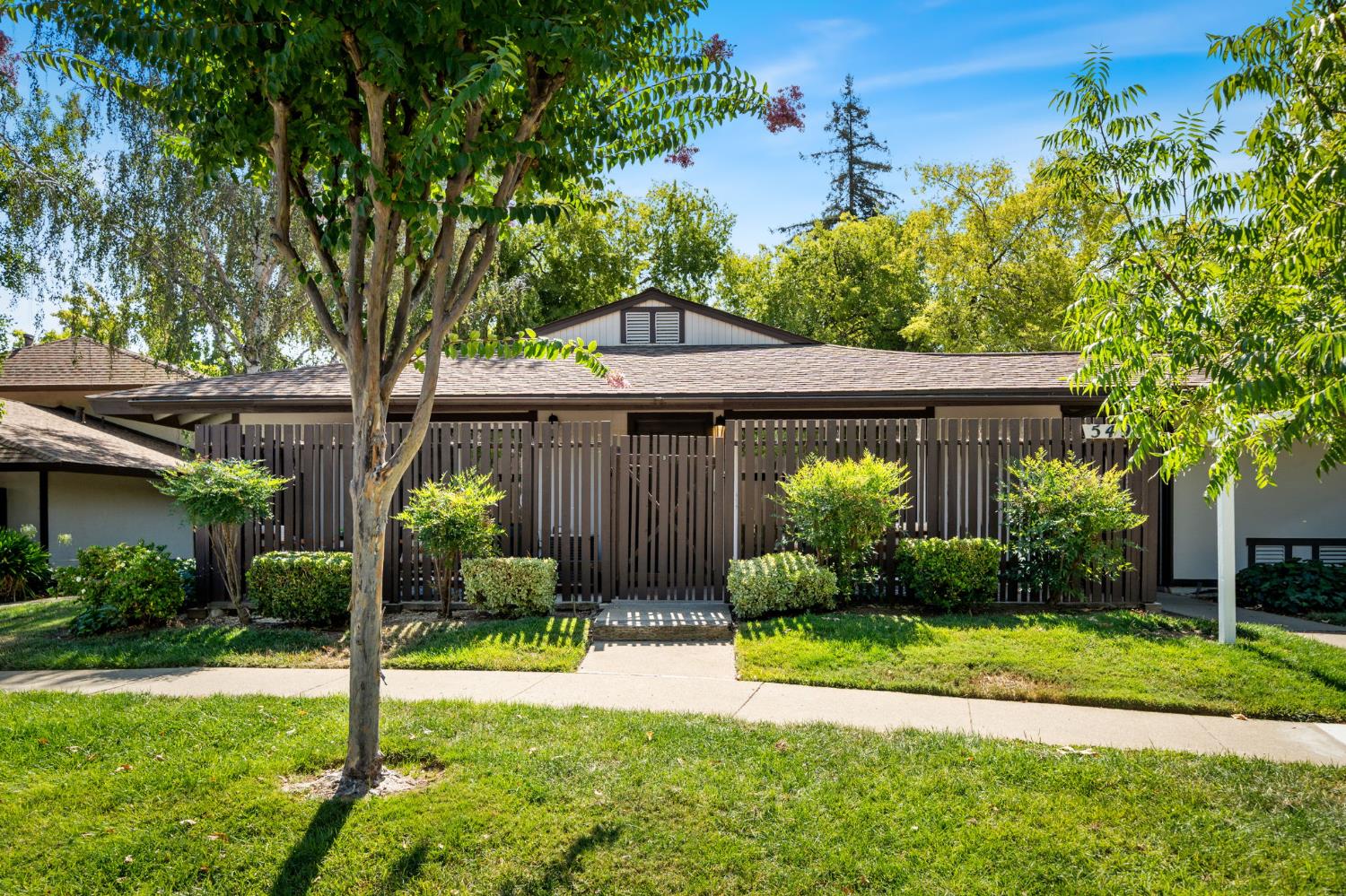 a front view of house with a garden
