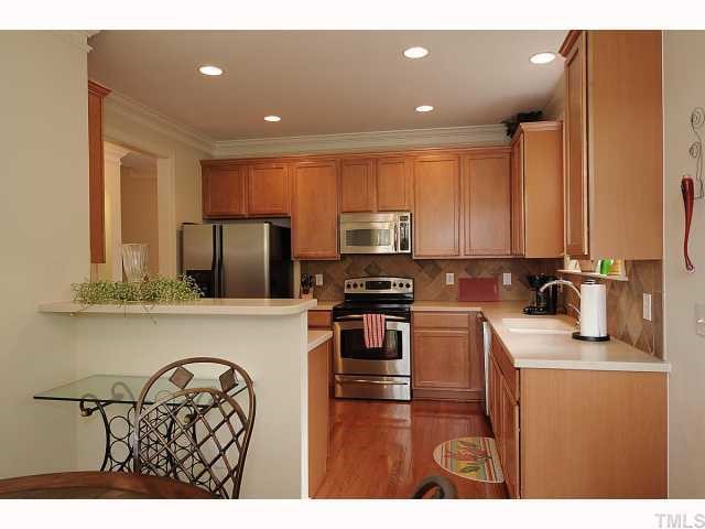 2306 Dunlin Lane Raleigh, NC 27614 - Photo 5 of 12 Kitchen faces wooded area and is bright with access to patio.