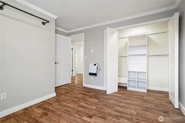 a view of empty room with wooden floor